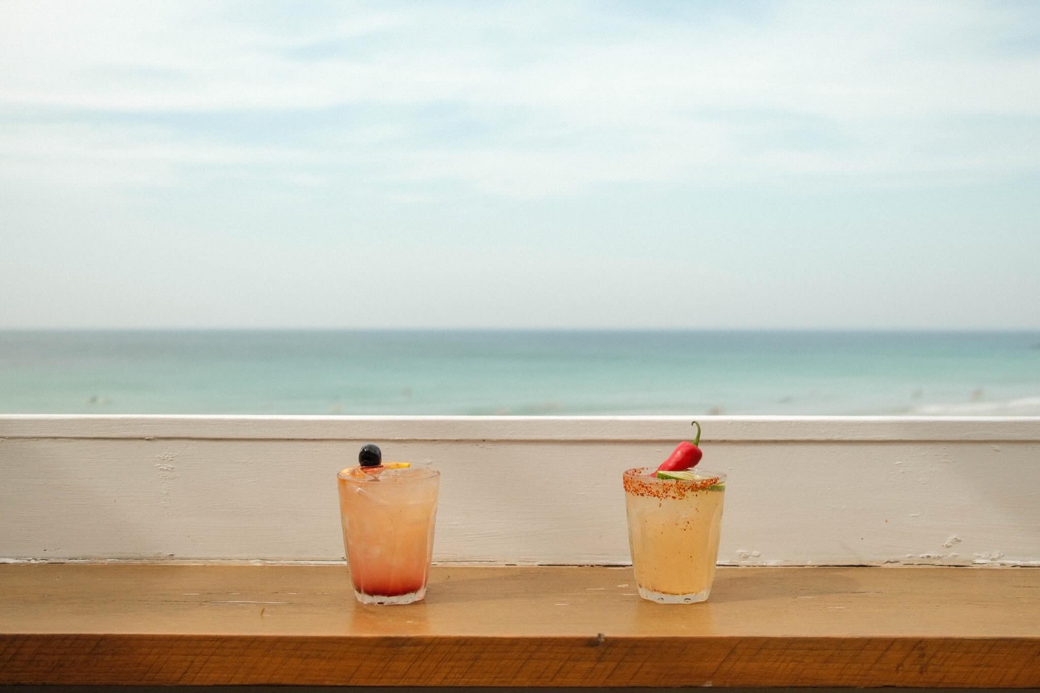 Two house cocktails served against the view of Porthmeor Beach